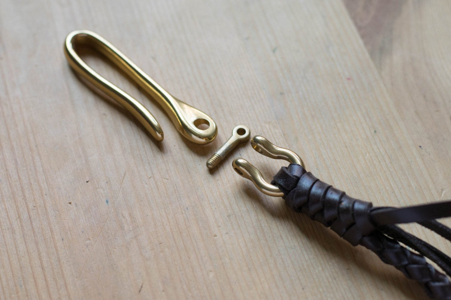 Brown braided leather strap with solid brass hardware - close up for solid brass fish hook