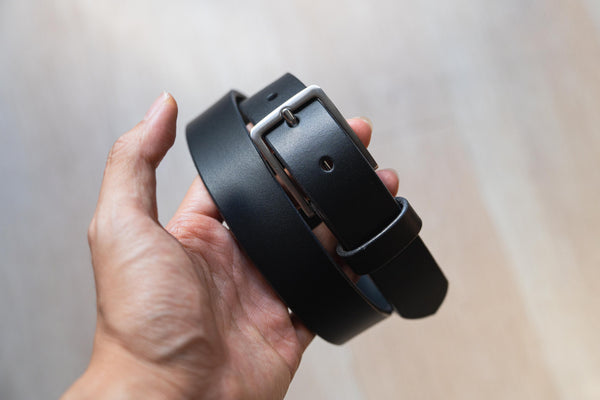 A black vegetable-tanned leather SS buckle dress belt with a stainless steel buckle and leather belt loop and belt tip - Front view