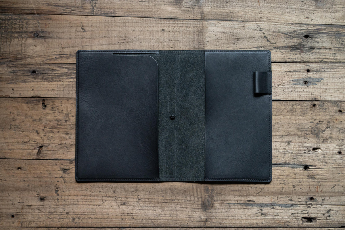 A black leather notebook cover display open 