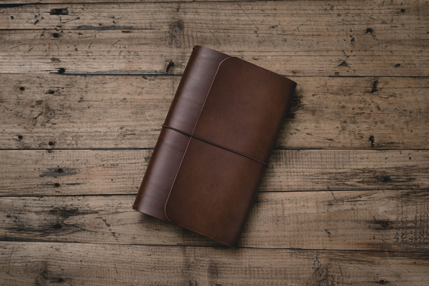 Brown Buttero Leather Trifold Traveler's Notebook Cover with brown elastic
