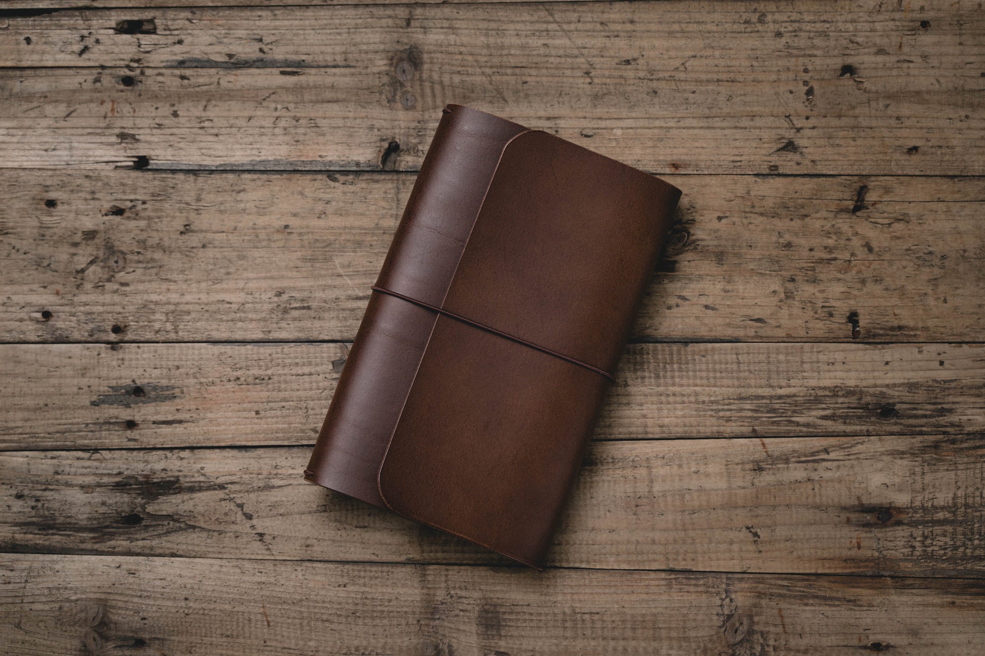 Brown Buttero Leather Trifold Traveler's Notebook Cover with brown elastic