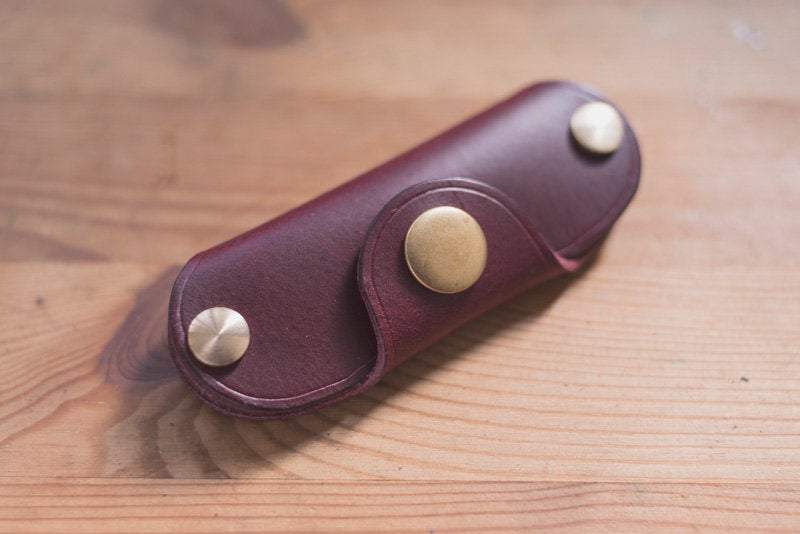 Burgundy  leather key holder with brass snaps and screws