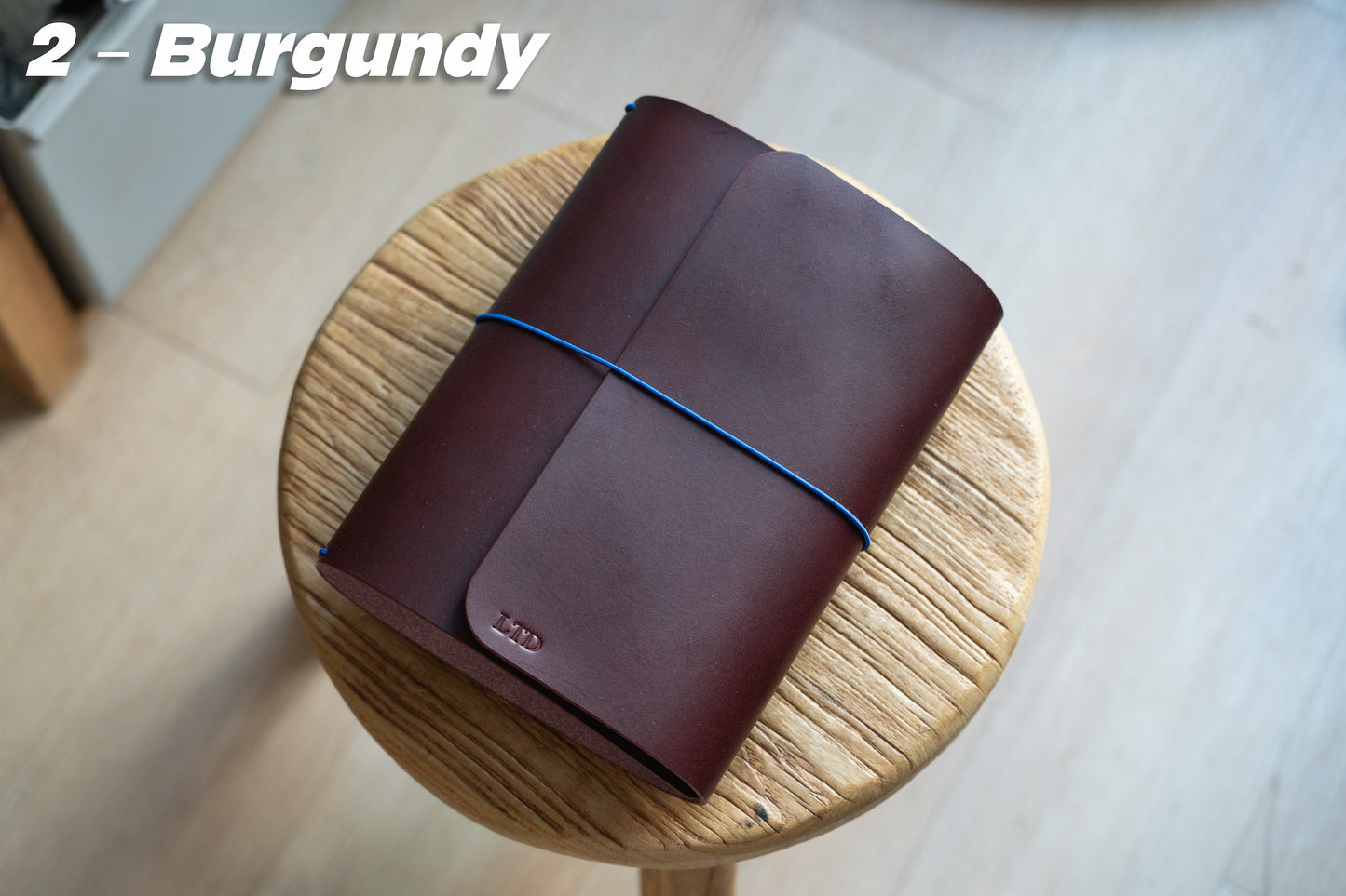 Burgundy Buttero Leather Trifold Traveler's Notebook Cover with blue elastic