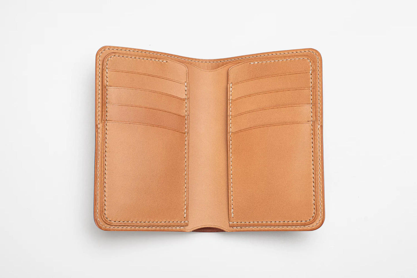 A caramel leather wallet shown open, featuring multiple card slots on both sides