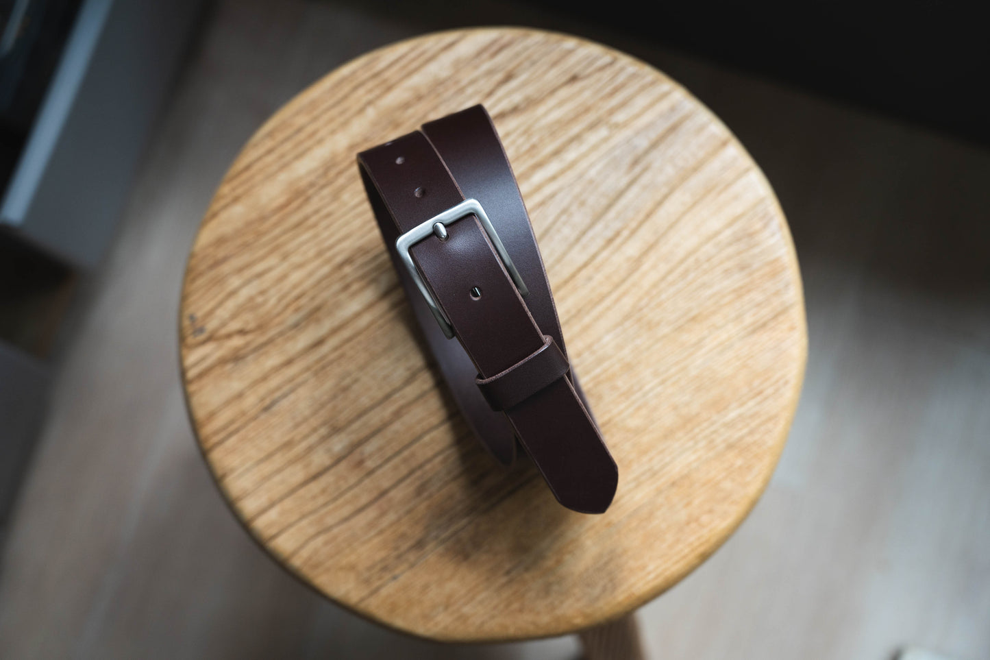 A chocolate vegetable-tanned leather SS buckle dress belt with a stainless steel buckle and leather belt loop and belt tip - Front view