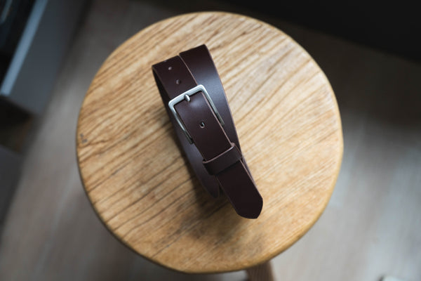 A chocolate vegetable-tanned leather SS buckle dress belt with a stainless steel buckle and leather belt loop and belt tip - Front view