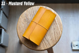 Mustard Yellow Buttero Leather Trifold Traveler's Notebook Cover with yellow elastic
