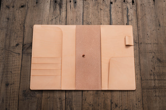 A natural leather notebook cover with three card slots on the left side, a flap on the right side.
