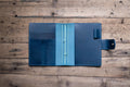 A navy blue Stitched Buttero Leather Traveler's Notebook with Card Slots and elastic strands and pen loop, displayed open