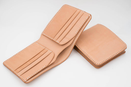 Two natural leather wallets with white stitching. The wallet on the left is open, showing the interior card slots. The wallet on the right is closed.