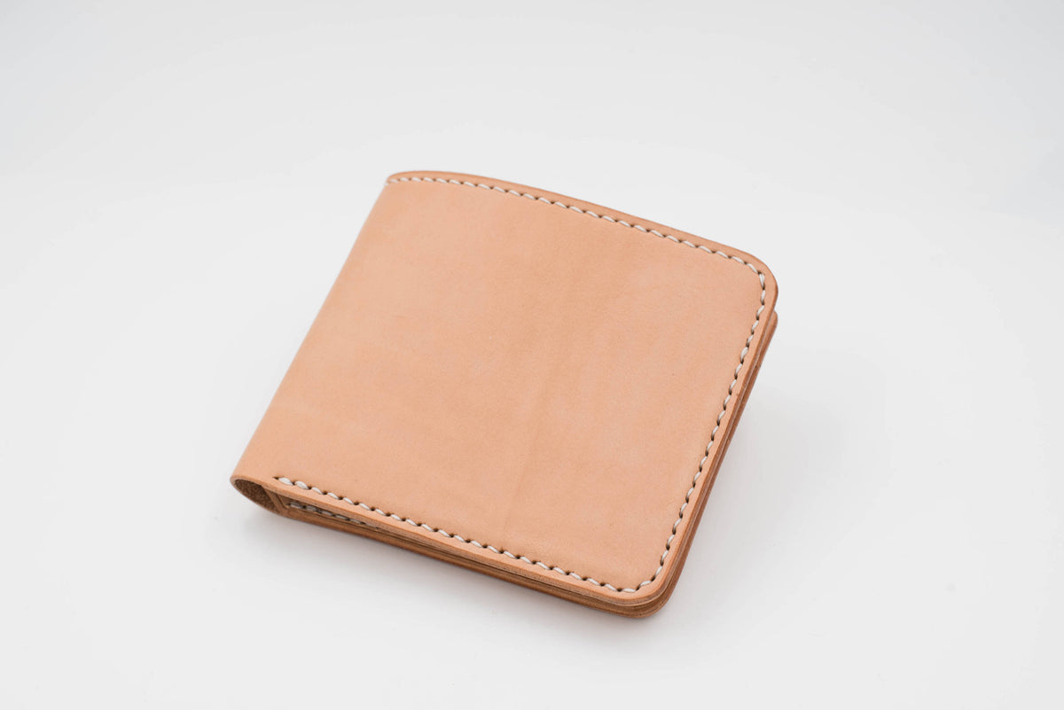 A natural leather wallet with white stitching around the edges.