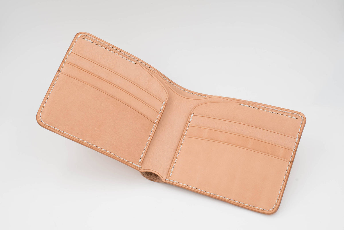 A natural leather wallet with multiple card slots and a fold-over closure. The wallet is open and the interior is visible.