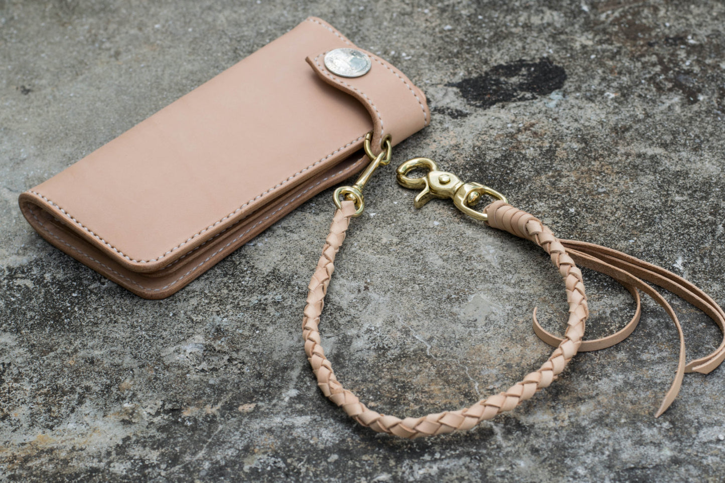 A round braid natural vegetable-tanned leather wallet rope with a solid brass trigger snap attached on biker wallet - lifestyle