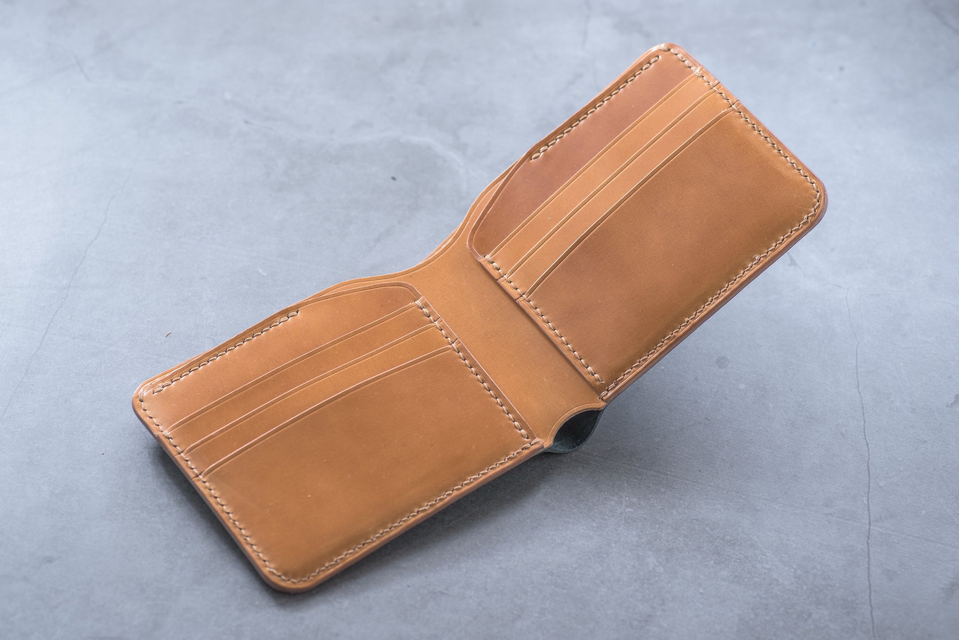 A whiskey leather wallet with 6 card slots and a fold-over closure.