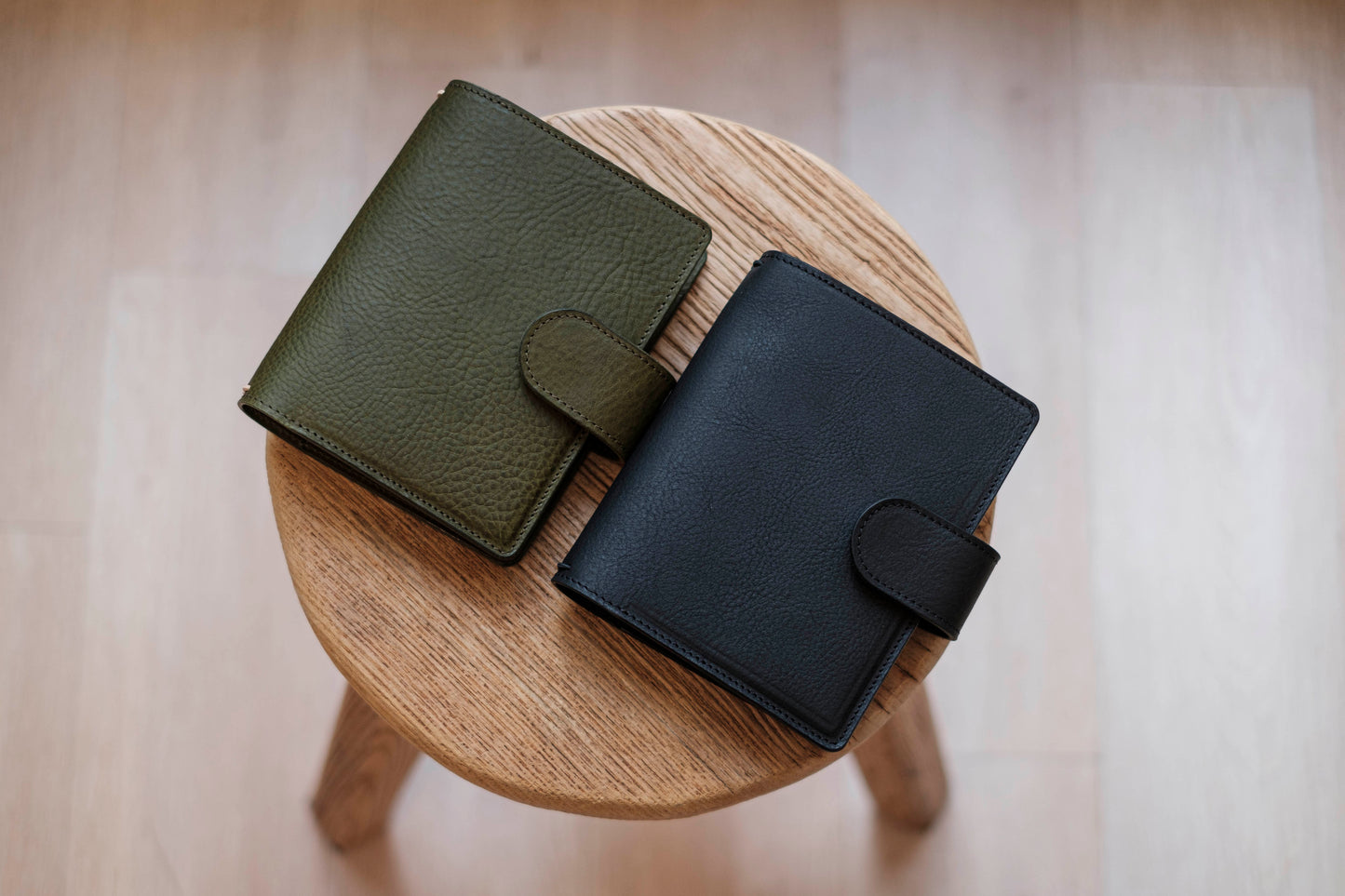 Two lined traveler's notebook with card slots and a leather strap, displayed close