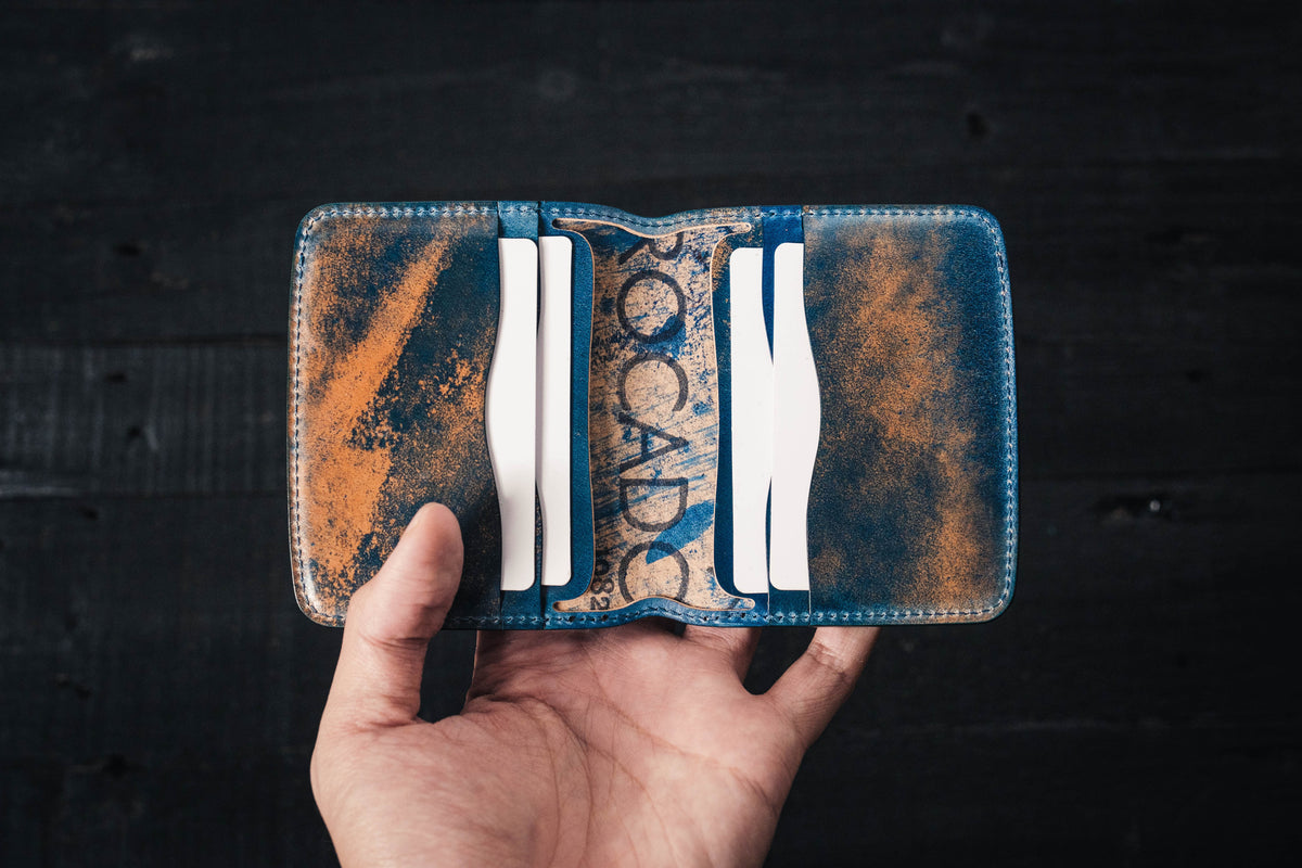 person holding a blue Rocado Shell Cordovan Contour Billfold Wallet display opened 