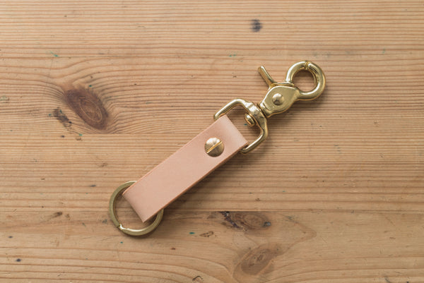 A natural leather key holder with a solid brass Chicago screw and trigger snap, back view