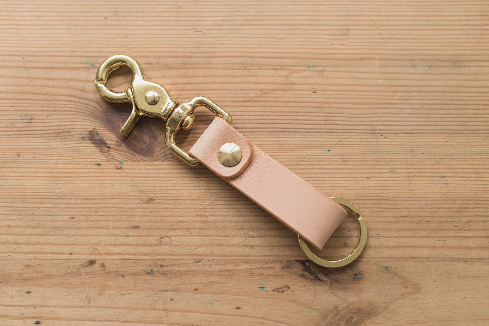 A natural leather key holder with a solid brass Chicago screw and trigger snap.