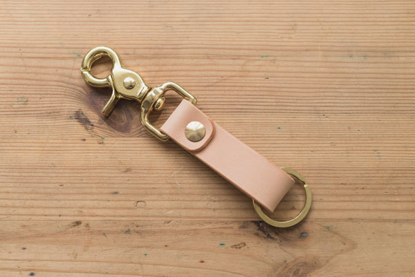 A natural leather key holder with a solid brass Chicago screw and trigger snap.