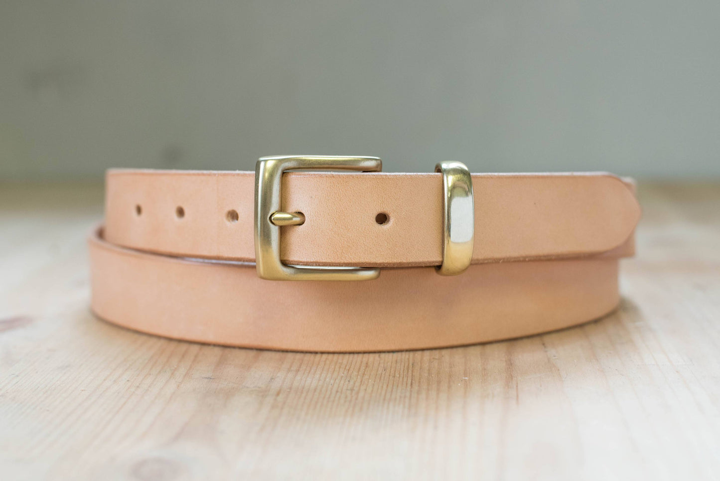 A natural vegetable-tanned leather dress belt with a solid brass buckle and solid brass belt loop - front view - 30mm wide