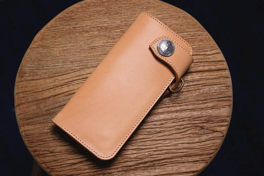 A natural leather biker long billfold wallet with a coin button concho