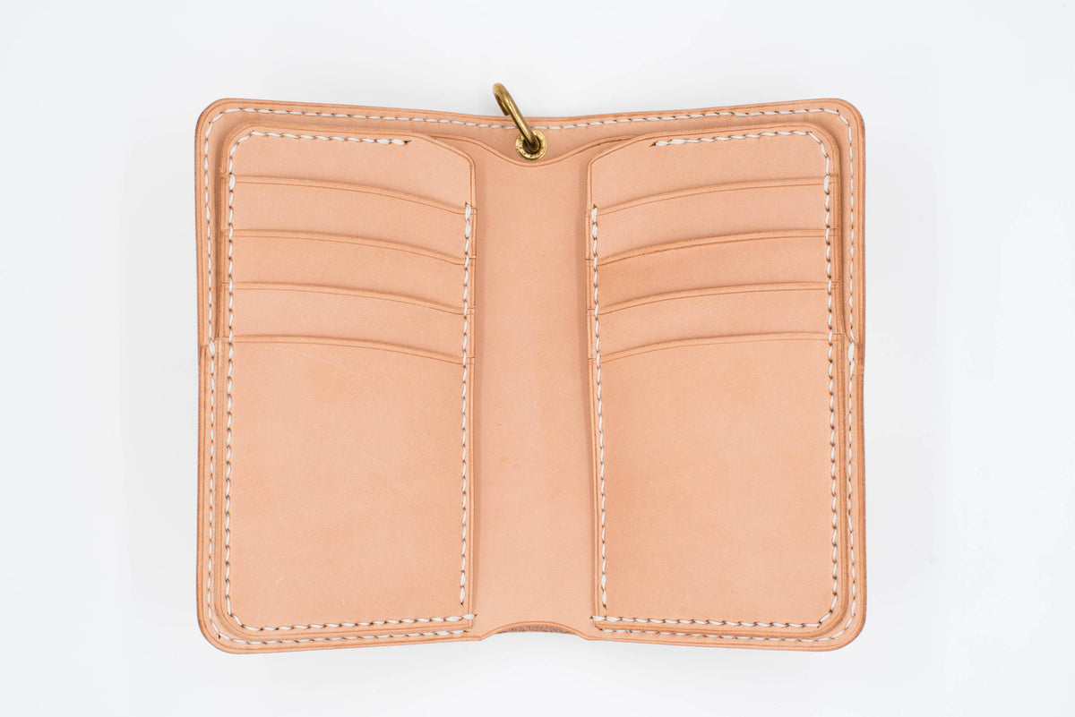 A natural leather wallet with multiple card slots and a snap closure. The wallet is open and empty.