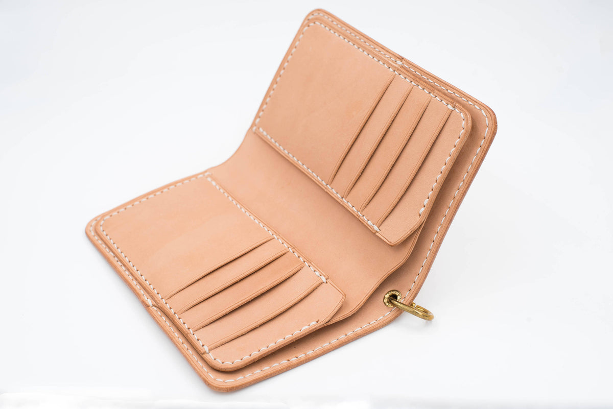 A natural leather wallet with 8 card slots and a snap closure. The wallet is open and the interior is visible.