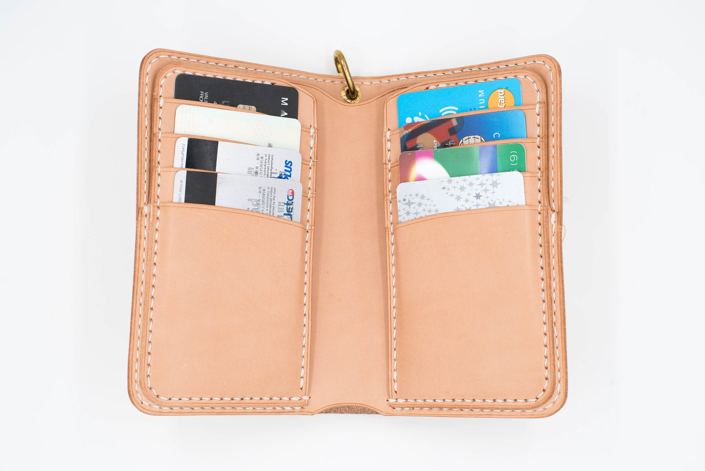 A natural leather wallet with 8 card slots, open to reveal several credit cards and debit cards inside.