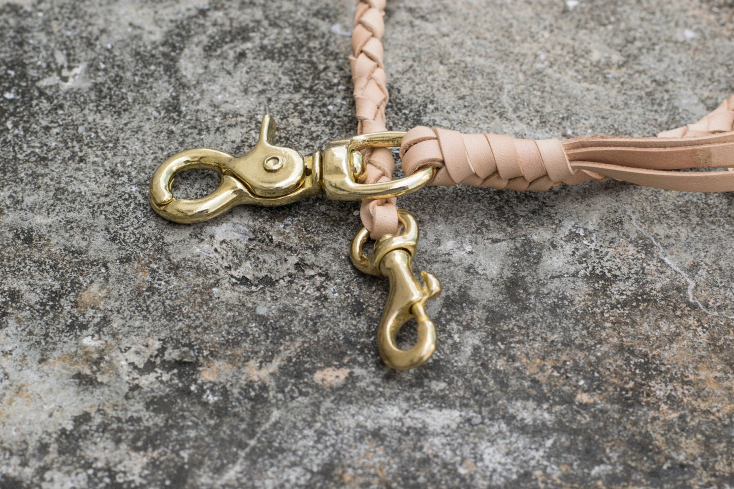 A round braid natural vegetable-tanned leather wallet rope with a solid brass trigger snap - close up for solid brass snap