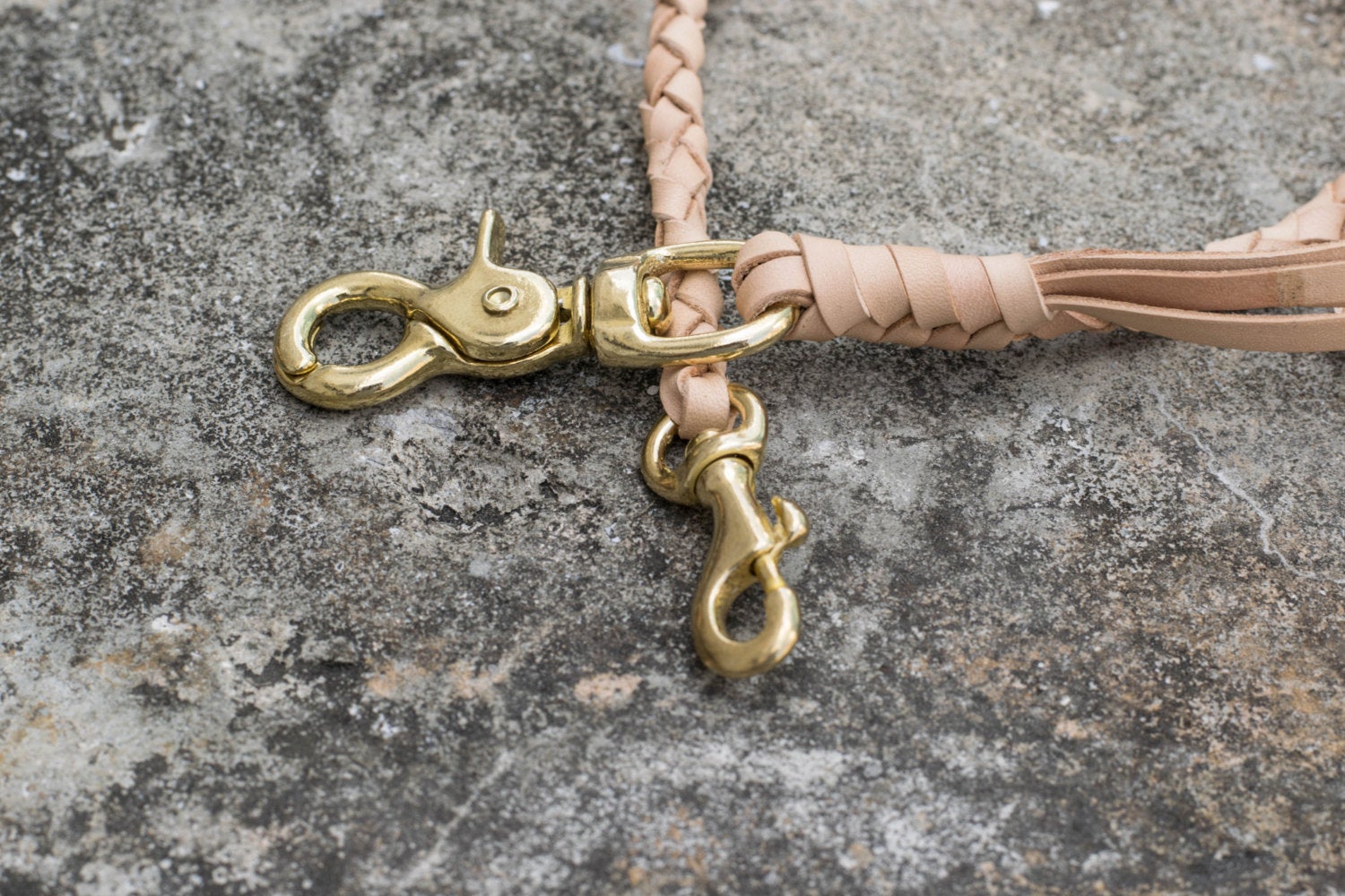 A round braid natural vegetable-tanned leather wallet rope with a solid brass trigger snap - close up for solid brass snap
