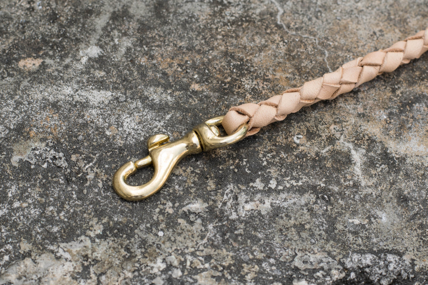 A round braid natural vegetable-tanned leather wallet rope with a solid brass trigger snap - close up for solid brass snap