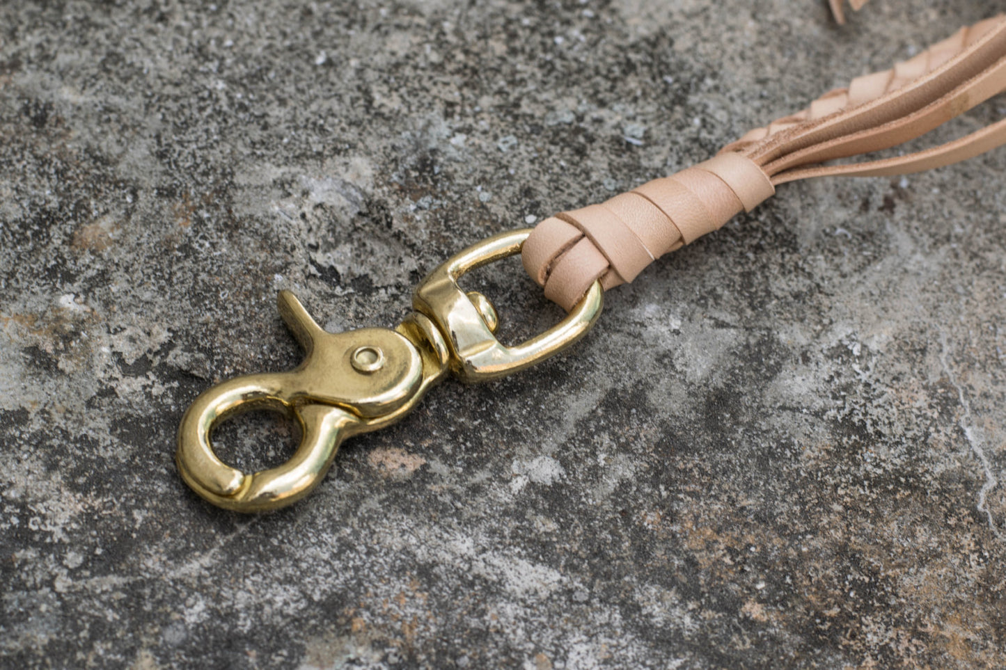 A round braid natural vegetable-tanned leather wallet rope with a solid brass trigger snap - close up for solid brass trigger snap