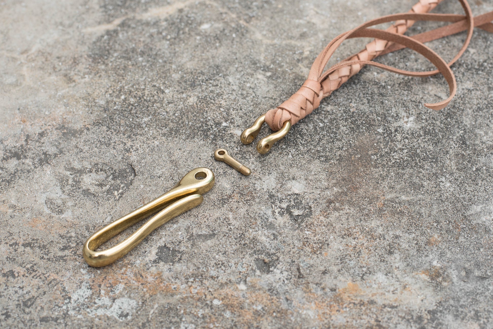 A round braid natural vegetable-tanned leather wallet rope with a solid brass hook - close up for the solid brass fish hook 