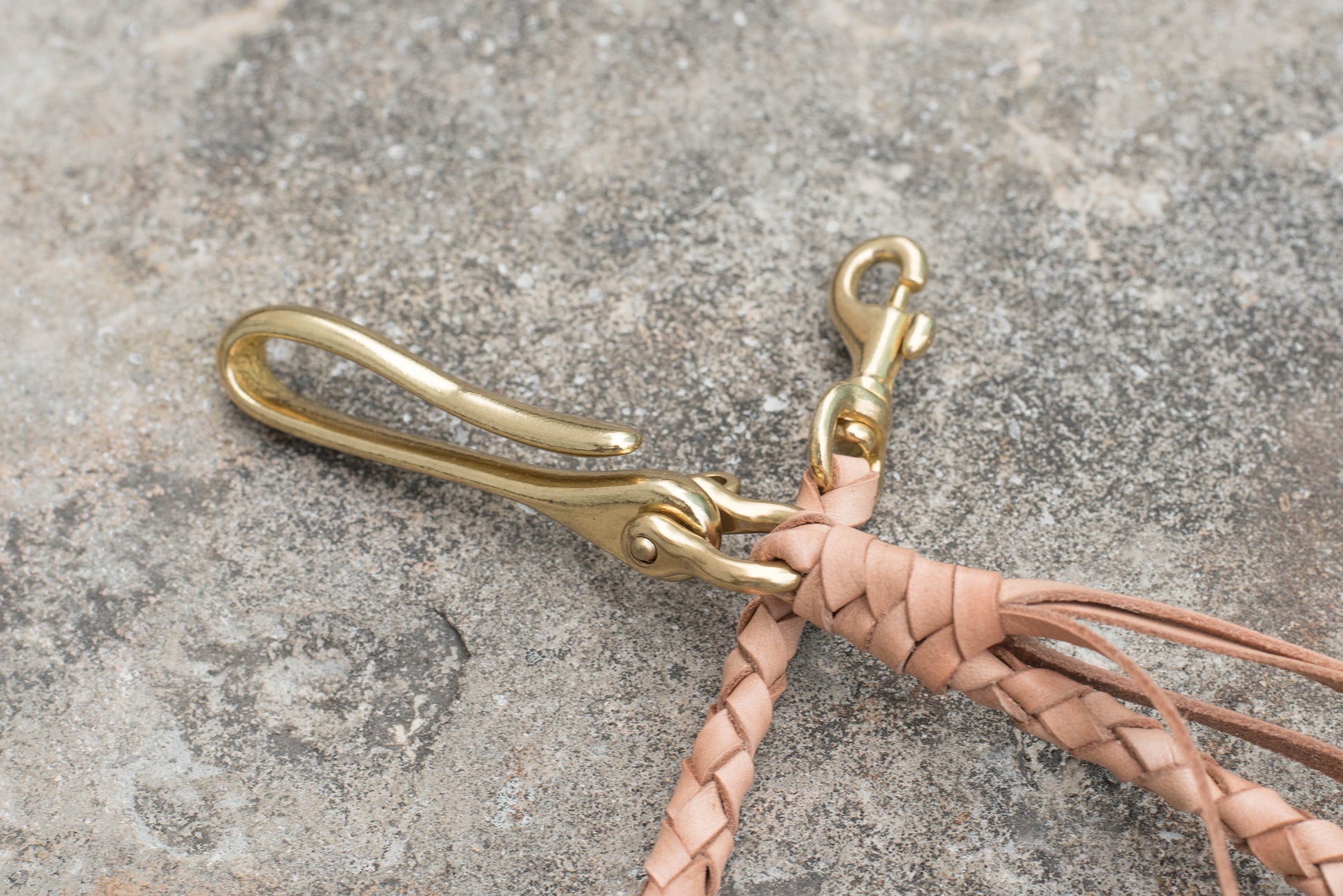 A round braid natural vegetable-tanned leather wallet rope with a solid brass hook - close up for the solid brass fish hook and snap