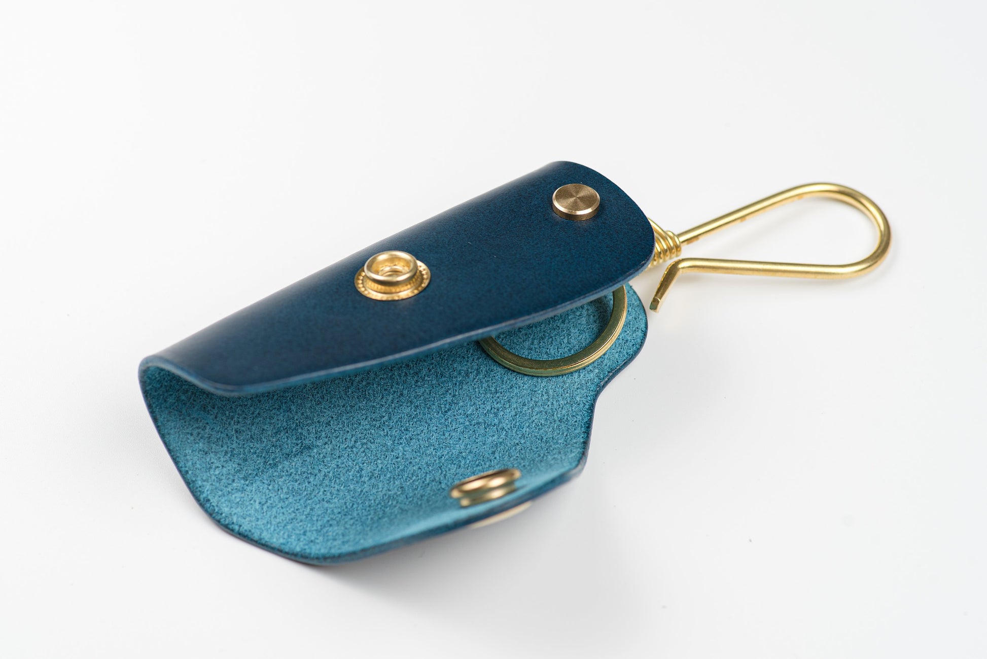 Navy Blue buttero Leather Key Case with brass hardware and a removable brass wire hook and key ring, displayed open.