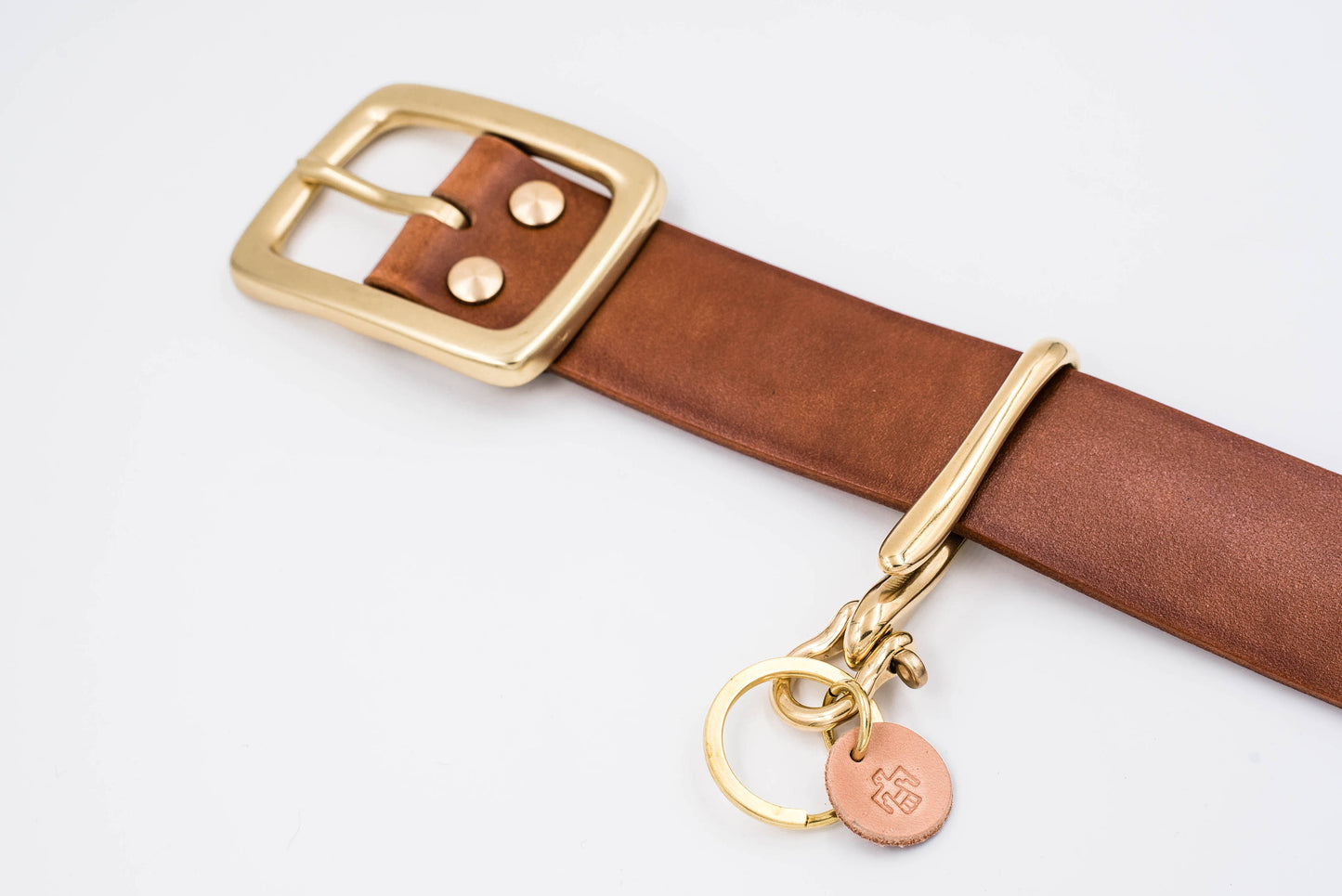 Solid Brass Fish Hook Key Holder matching with  a Tan Leather Garrison Belt - Lifestyle view