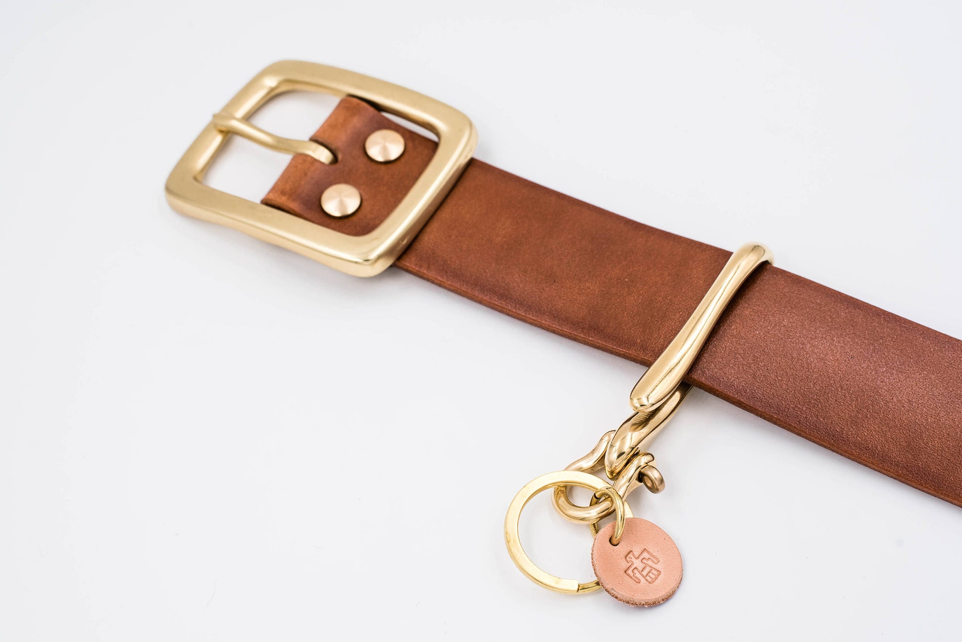 Solid Brass Fish Hook Key Holder matching with  a Tan Leather Garrison Belt - Lifestyle view