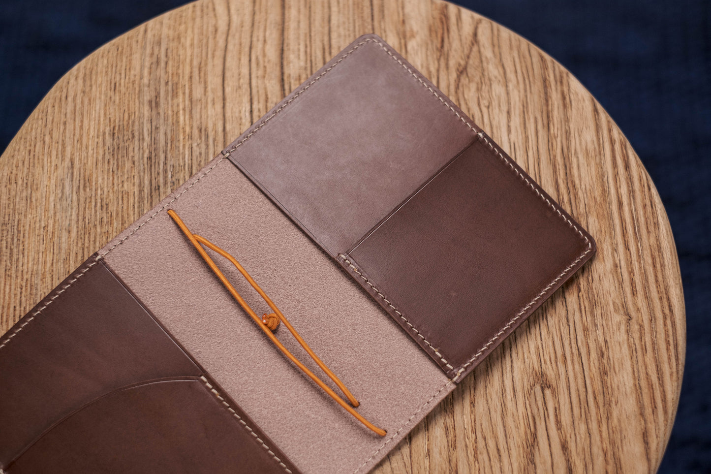 A brown Stitched Buttero Leather Traveler's Notebook and a elastic enclouse, displayed open, close up for inside right pocket